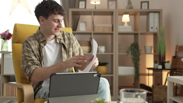 man use digital tablet show papers letter document video call at home