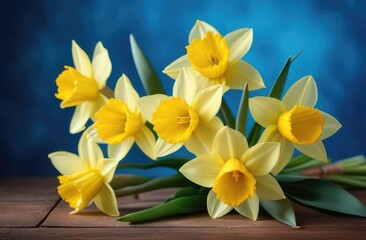 mothers Day, international Womens Day, St. Davids Day, bouquet of yellow daffodils, spring flowers, blue background, wooden table