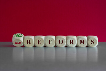 Good or bad reforms symbol. Concept words Good reforms Bad reforms on wooden cubes. Beautiful grey...