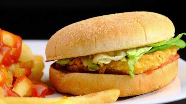 Cheeseburger hamburger and fried potatoes close-up