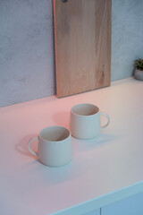 Mug with coffee on the table. A cup of tea on the table.