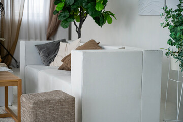 Apartment interior with a large sofa. White sofa.