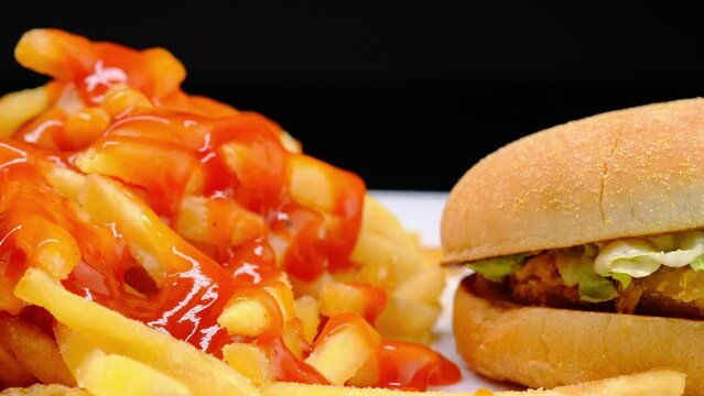 Cheeseburger hamburger and fried potatoes close-up
