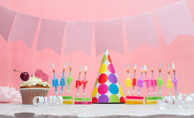 Birthday background. Anniversary. Beautiful festive background with candles for a girl. Women's congratulations card with a cake. Happy birthday in pink. copy space