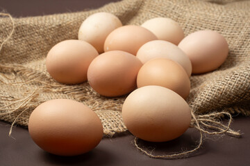 Fresh chicken eggs on burlap.