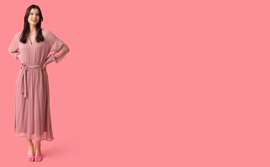 Beautiful young woman in stylish dress on pink background with space for text