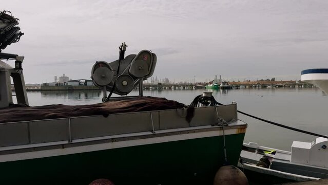 Trawlers in the port of Spain in winter. Fishing boats are moored at the pier. A port in the Mediterranean Sea on a sunny day in February.