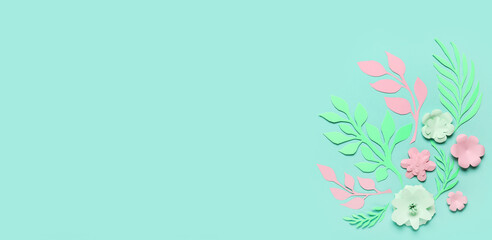 Beautiful paper flowers and leaves on turquoise background with space for text
