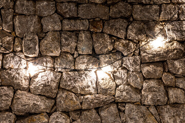 three lamp bulbs on a old vintage stone wall background in loft or vintage style , concept for design