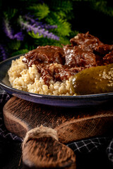 Chunky beef stew with savory sauce, served with bulgur groats.