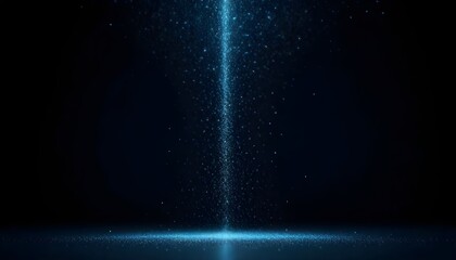A beam of light shining down onto a surface with particles floating in the air against a dark background