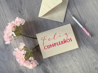 A card with the Spanish phrase Feliz Cumpleanos that means Happy Birthday. © tilialucida