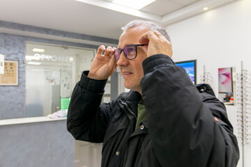Mature man trying out a glasses at the ophthalmologist