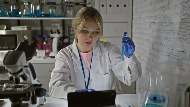 A focused woman scientist examines a test tube in a modern laboratory setting, portraying concentration and expertise.