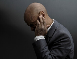 deafness suffering from hearing loss on grey black background with people stock image stock photo	