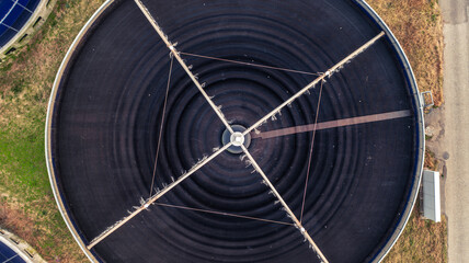 Aerial top view of massive round water tank for water filtration.