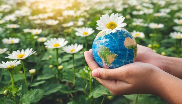 earth day or world environment day concept save our planet restore and protect green nature sustainable lifestyle and climate literacy theme blooming rose daisy flowers on globe in hand 22 april