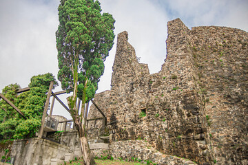 ruins and destroyed walls with the foundation of an old fortress and fortress wall, in an ancient...