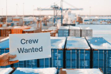 Banner Poster Paper With The Phrase Crew Wanted With A Logistics Terminal In The Background