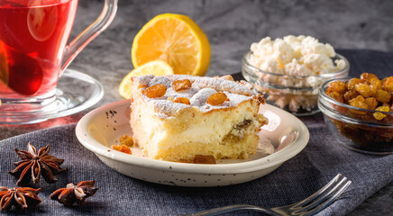 Homemade cheesecake with raisins. Pieces of cheesecake with raisins and lemon slices and tea