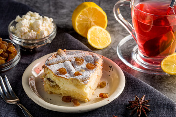 Homemade cheesecake with raisins. Pieces of cheesecake with raisins and lemon slices and tea