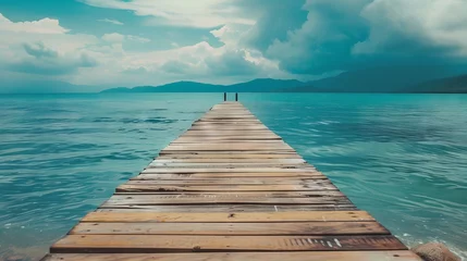  A wooden pier that stretches out to the sea,seascape view with Mountain and cloudy sky for travel in holiday relax time as summer © Jalal