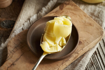 A spoonful of ghee or clarified butter on a table