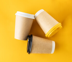 three paper cups of coffee, laid out in a triangle, recycled