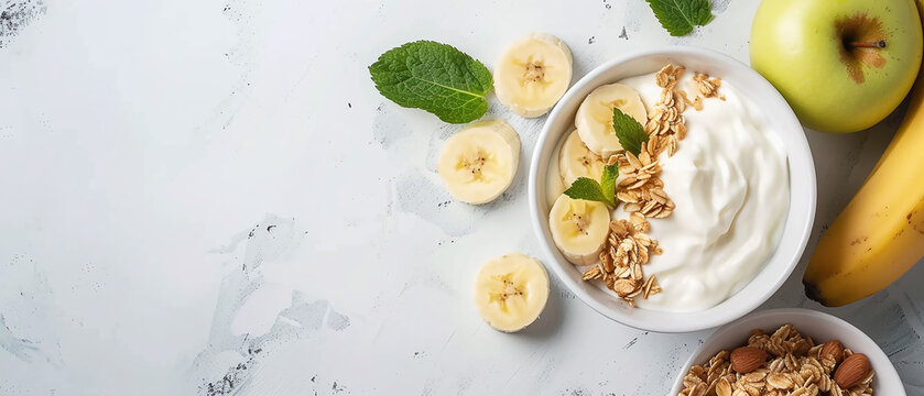 Healthy breakfast with natural yogurt, muesli, apple and bananas