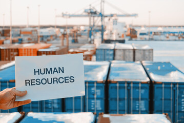 Banner Poster Paper With The Phrase Human Resources With A Logistics Terminal In The Background