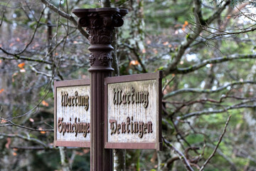 An old cast iron sign along the hiking trail indicates 