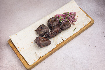 a delicious meat dish of Asian cuisine in a restaurant or pub. Close-ups
