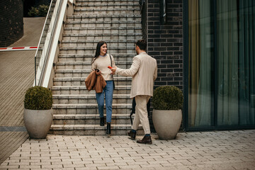A man and a woman networking outdoors amidst bustling city streets
