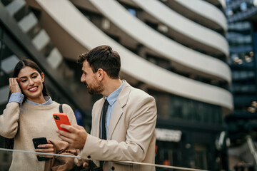 Two business professionals engaged in conversation against a backdrop of modern skyscrapers