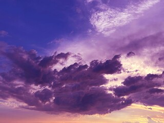 Sky clouds purple dramatic stormy heaven cloudscape at sunset.