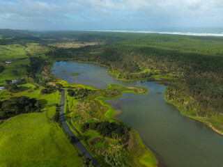 Aerial: Farlmland,lake and forestry on the west coast. Helensville, Auckland, new Zealand.