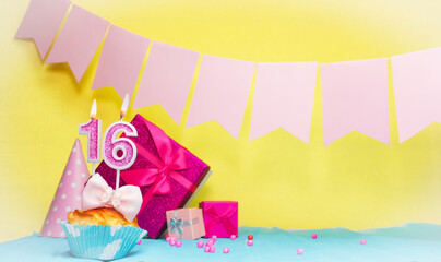 Date of birth with cake and number 16. Colorful card happy birthday for a girl. Copy space. Anniversary card pink. Congratulations on the decorations are beautiful.
