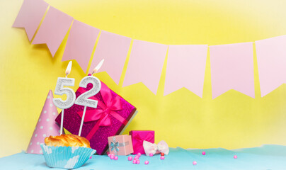 Date of birth with cake and number  52. Colorful card happy birthday for a girl. Copy space....
