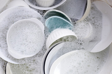 Fototapeta na wymiar Dish washing, Dirty dishes soaking in kitchen sink.