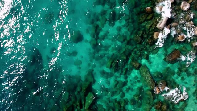 Aerial: Drone Top Backward Scenic View Of Rocks In Turquoise Lake On Sunny Day - Tahoe City, California