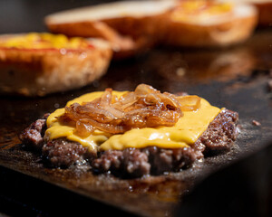 Delicious beef hamburger with cheese on the grill