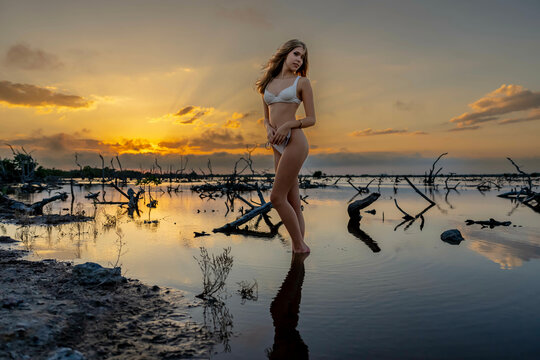 Tropical Tranquility: Radiant Beauty Strikes a Pose Amidst Lush Mexican Landscape as Yucatan Sunsets Paint the Sky