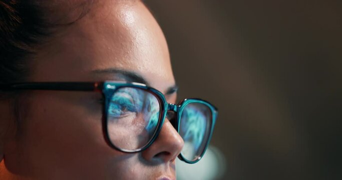 Woman, eyes and coding with glasses for programing, research and development at office. Closeup or face of female person, programmer or coder in focus for algorithm or problem solving at workplace
