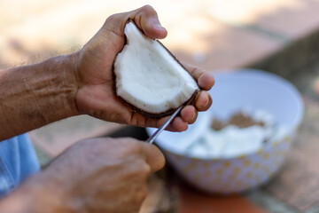 Coconut in the hands of an elderly man, 