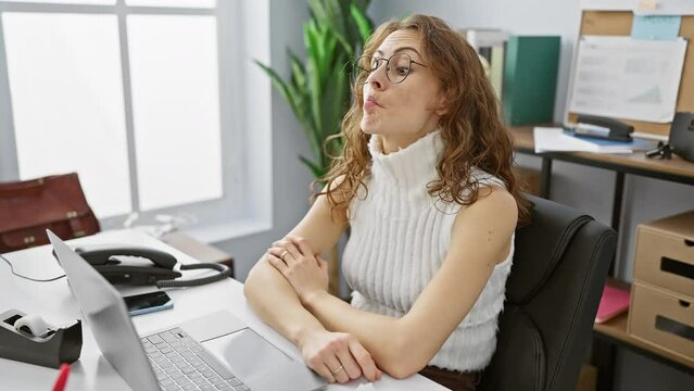 Crazy fun at the office! beautiful, confident young woman working, pulling a comical fish face gesture with her lips. silly yet charming, making for a truly funny expression.