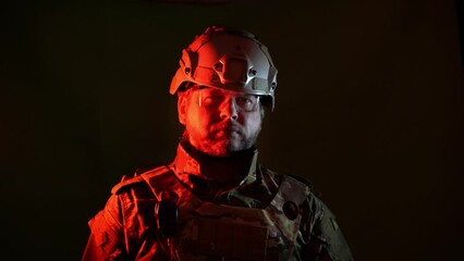 A courageous military soldier is a man on a dark background