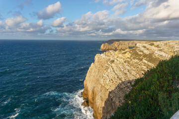 Cliff at the atlantic coast at Cabo Sao Vicente with beautiful clear blue sea water, Sagres, Algarve, Portugal