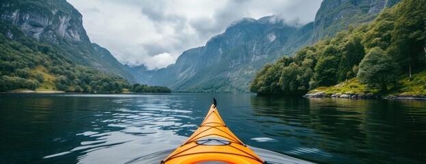 A yellow kayak is seen floating in the middle of a calm lake, surrounded by the majestic mount b45.