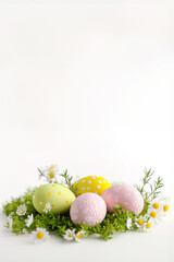 Fototapeta premium Decorative Easter eggs banner over white background. Vertical image with copy space for advertisement
