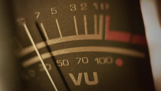 Macro shot of a studio VU, volume meter. Symbol of music production, recording and live show broadcasting. A pro equipment video loop, with a natural color aesthetic. Ideal also for intros or logos